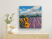 Painting of sunflowers and lavender field on a wall above a wooden cabinet with decorative vases.