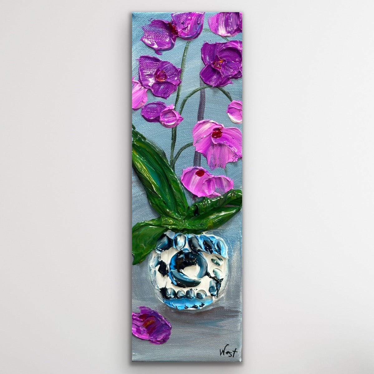 Painting of pink orchids with a blue and silver object on a gray background