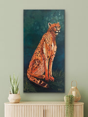 Painting of a cheetah on a wall above a cabinet with decorative items.