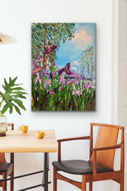 Painting of irises on a wall above a dining table with chairs.