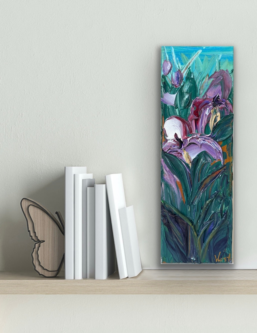 Palette knife painting of iris flowers on a shelf with books and a butterfly decoration.