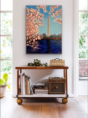 Room interior with a wooden cart, books, and a painting of cherry blossoms and the Washington Monument.