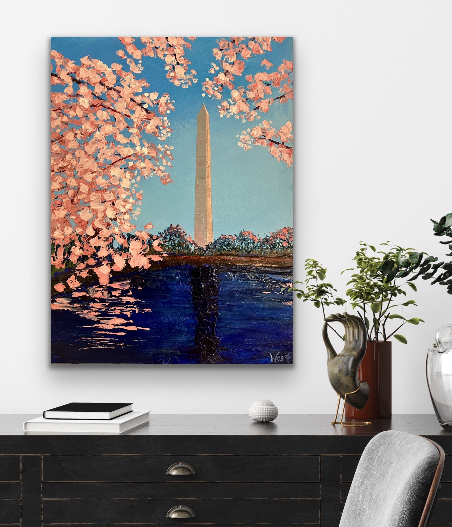 Original painting of cherry blossoms and the Washington Monument on a wall above a desk.