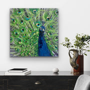 Painting of a peacock with green feathers and a blue head on a wall above a desk.