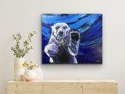 Painting of a polar bear on a blue abstract background in a room with decorative elements.