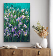 Floral iris palette knife impasto painting on a wall above a wooden cabinet with decor items.