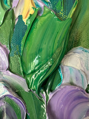 Close-up of colorful impasto palette knife paint in green, purple, and other colors.
