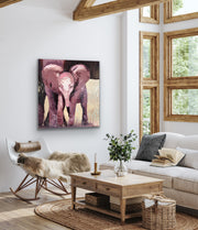 Living room with a painting of two elephants on the wall, a couch, coffee table, and rocking chair.