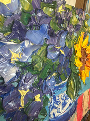 Close-up of an impasto palette knife painting with sunflowers and other flowers.
