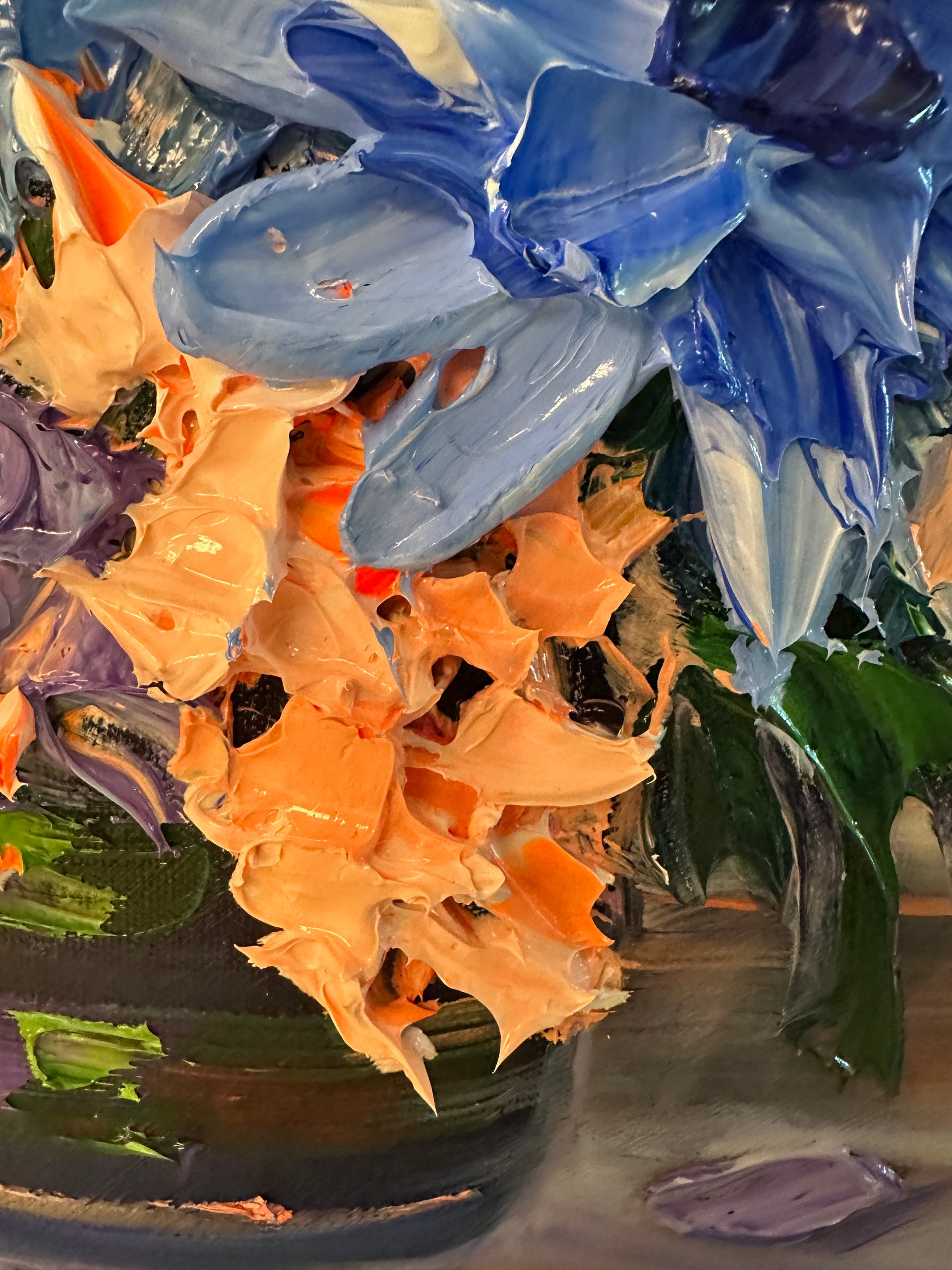 Close-up of colorful palette knife painting of flowers with blue, orange, and purple hues.