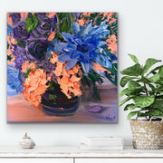Floral palette knife painting with blue and orange flowers on a white wall above a shelf.