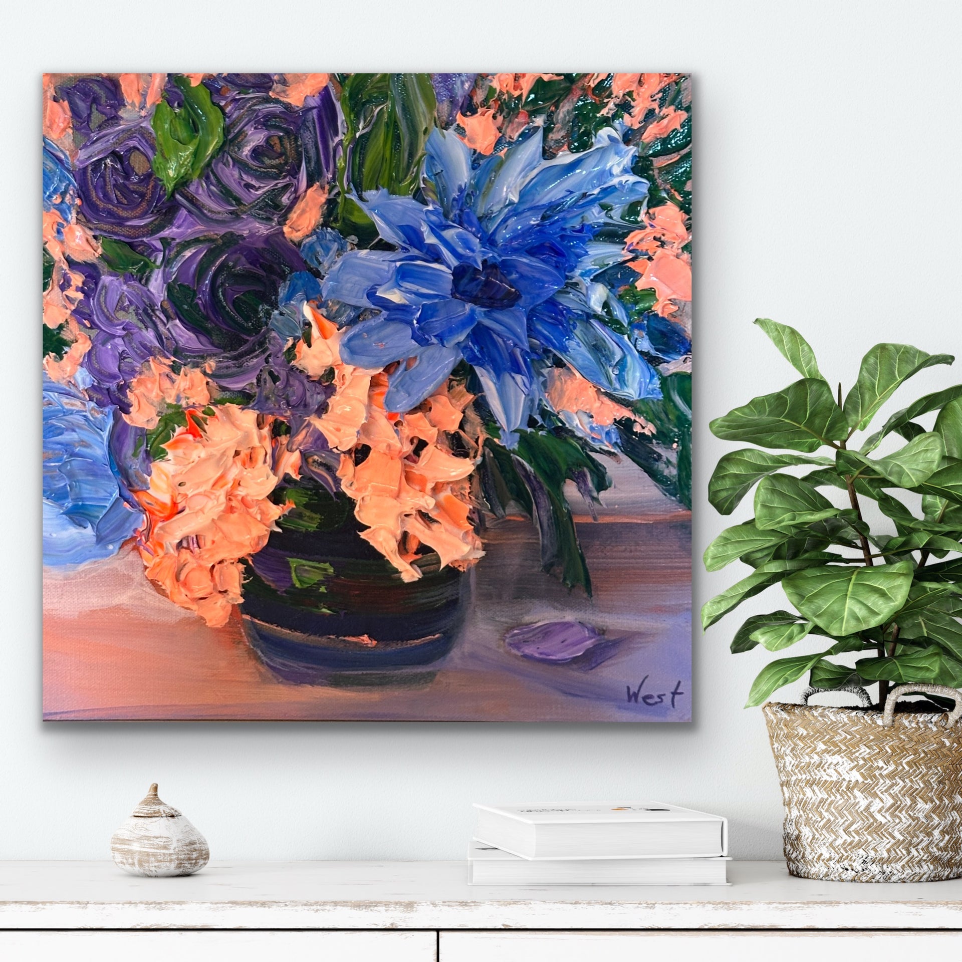 Floral palette knife painting with blue and orange flowers on a white wall above a shelf.