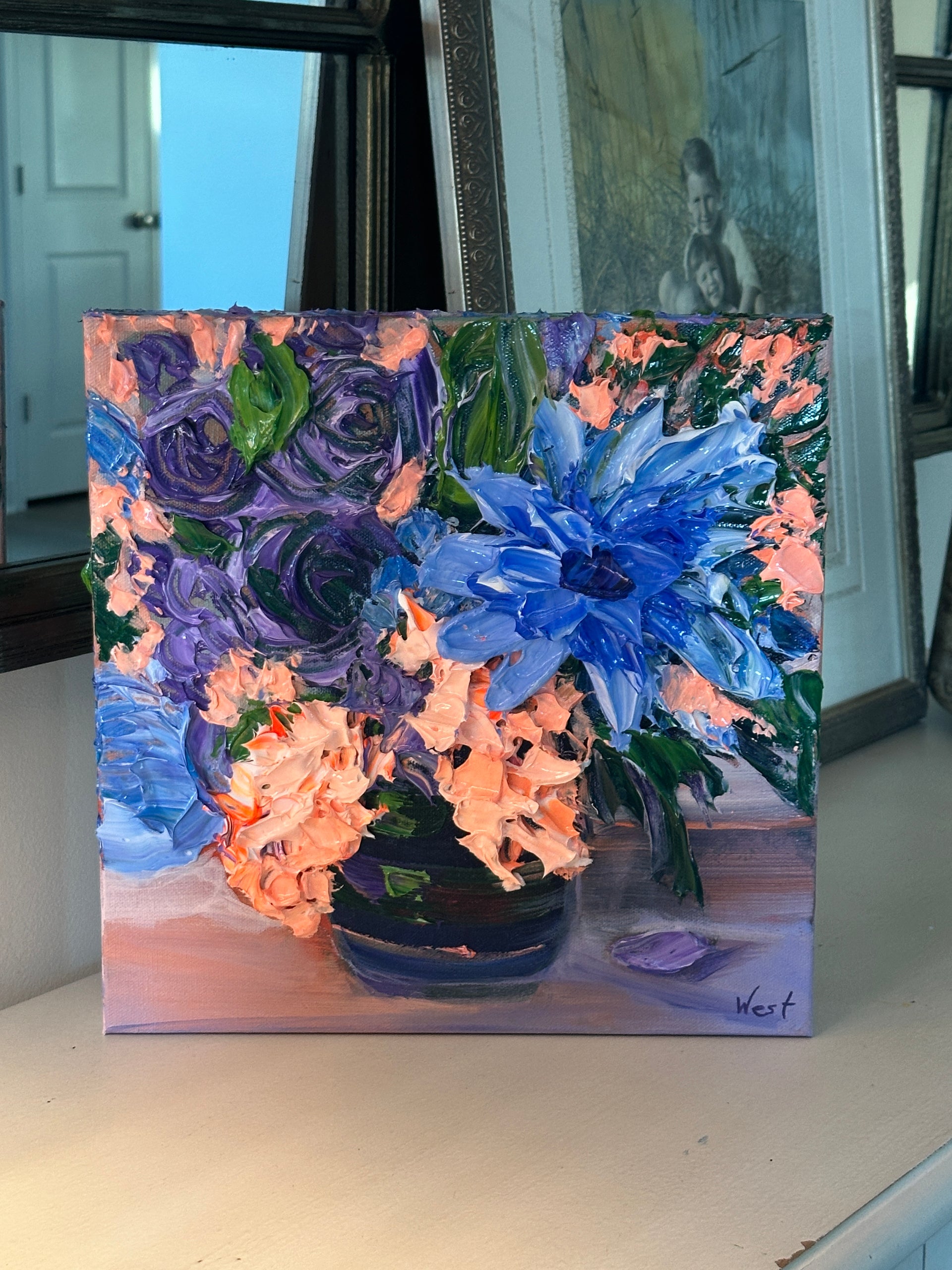 Floral palette knife impasto painting with blue and purple flowers on a wall